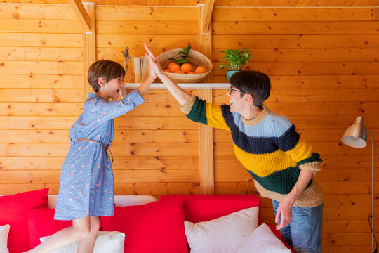 Happy mother and daughter preparing countryside property to welcome guests