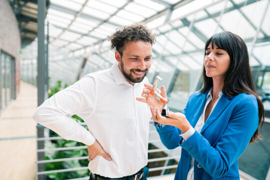 Professional colleagues analyzing robot model at office