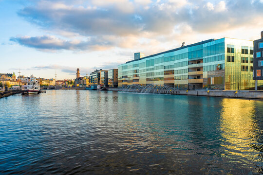 Malmo University by harbor against sky in city