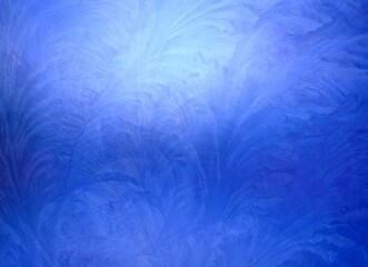 Fototapeta na wymiar Deep blue frosted glass half transparent surface covered winter pattern. Low lighting textured background.
