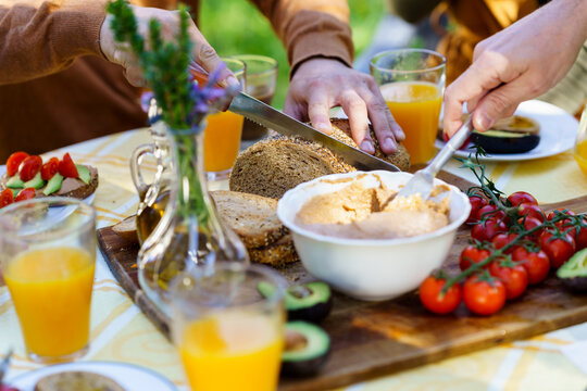 Friends Enjoying A Healthy Vegan Breakfast In The Countryside