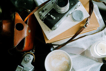 Vintage old Soviet photo camera with cup of coffee