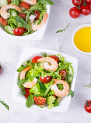 Delicious and healthy shrimp salad with herbs and tomatoes. Dietary nutrition for weight loss. Recipe for cooking fresh seafood. Mediterranean cuisine.