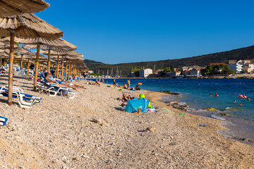 Fototapeta na wymiar The beach in Primosten town the coast of the Adriatic Sea, Croatia