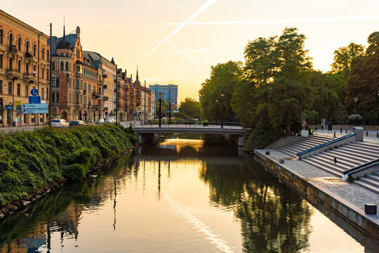 Houses by Sodra Forstadskanalen in city during sunset