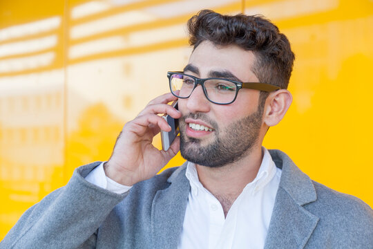 Portrait of bearded young businessman on the phone