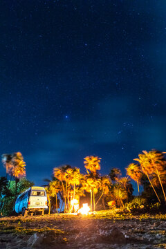 Mexico, Yucatan, Quintana Roo, Tulum, camper van on the beach at night with palm trees