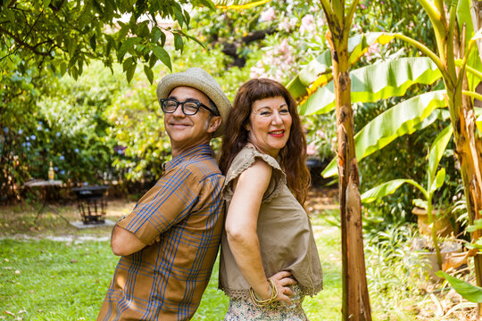 Portrait of mature couple, back on back