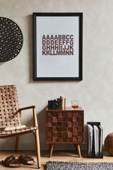 Creative composition of elegant masculine living room design with mock up poster frame, brown armchair, designed commode and personal accessories. Template.