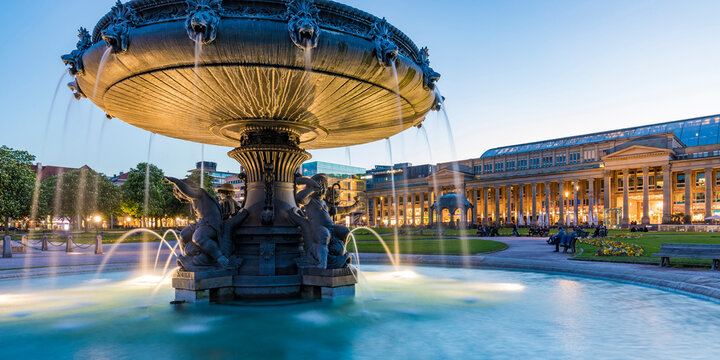 Palace square with fountain in front of Koenigsbau at dusk, Stuttgart, Germany
