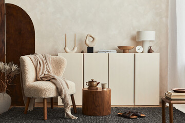 Stylish composition of cozy living room interior design with mock up poster frame, fluffy armchair, folding screen, coffee table, commode and personal accessories. Modern style. Template.