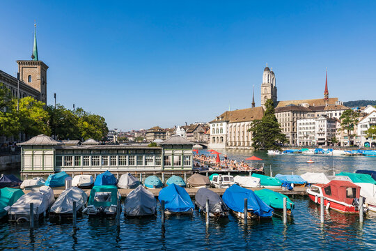 Switzerland, Canton of Zurich, Zurich, Boats moored on Limmat river with swimming pool in background