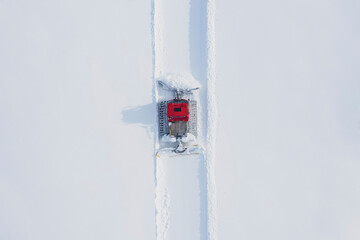 Austria, Tyrol, Galtuer, view to ski slope and snow groomer in winter, aerial view
