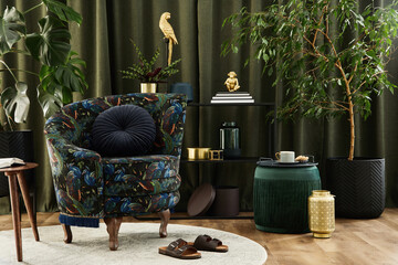 Stylish interior of modern living room with retro design armchair, plants, pouf and creative...
