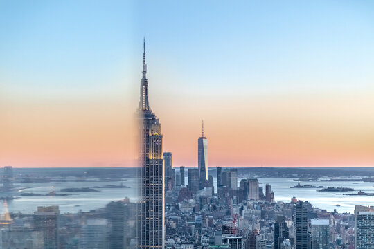 Skyline at sunset with Empire State Building in foreground and One World Trade Center in background, Manhattan, New York City, USA