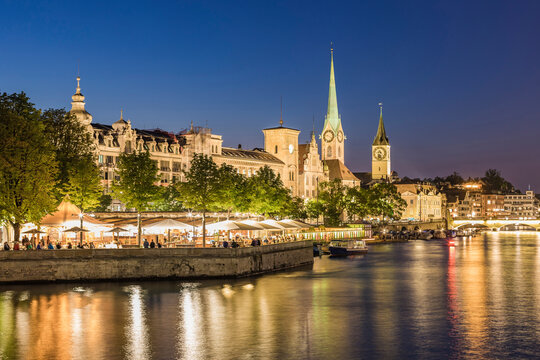 Switzerland, Canton of Zurich, Zurich, River Limmat and illuminated old town waterfront buildings at dusk