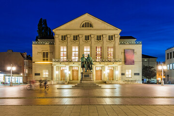 Germany, Thuringia, Weimar, Theaterplatz, German National Theater with Goethe and Schiller statues at night