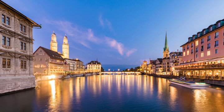 Switzerland, Canton of Zurich, Zurich, River Limmat between illuminated old town waterfront buildings at dusk