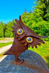 Funny iron rusty owl on a stone.