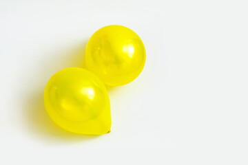 two yellow balls on a white background, top view, flat lay