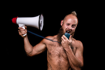 Frustrated male shirtless viking screaming on himself through megaphone against black background