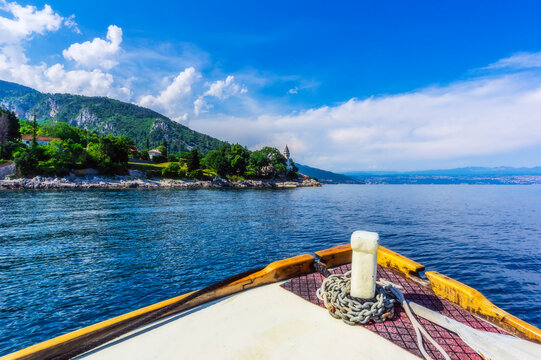 Cropped image of boat moving on Adriatic sea by mountain against sky