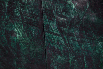 wooden background. treated dark wood surface. green unusual texture