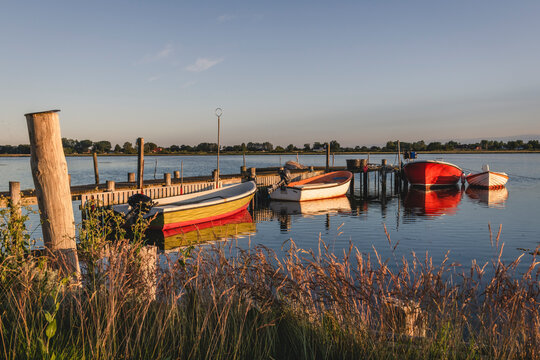 Denmark, Region of Southern Denmark, Ommel, Motorboats moored to coastal jetty at dusk