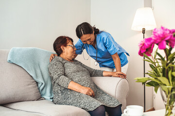 Caregiver, carer hand holding elder hand woman in hospice care. Philanthropy kindness to disabled concept.Public Service Recognition Week. Attentive young doctor talks with female patient