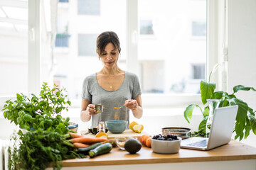 Woman preparing healthy food in her kitchen