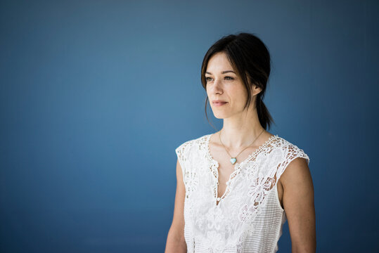 Portrait Of A Beautiful Woman Against Blue Background