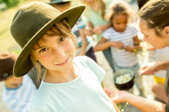 School children learning, how to prepare a chamomile infusion, girl smiling at camera