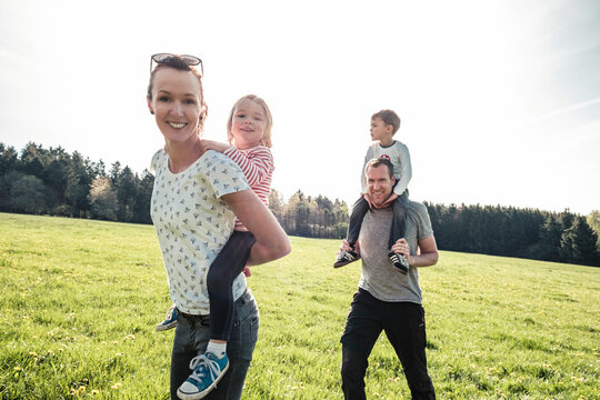Happy family with two kids on a meadow in spring