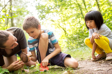 Boy and tcher examining mushroom in nature