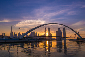 Fototapeta na wymiar Beautiful Sunrise View of Tolerance Bridge in Dubai Canal