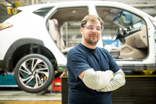 Portrait of confident worker in modern car factory