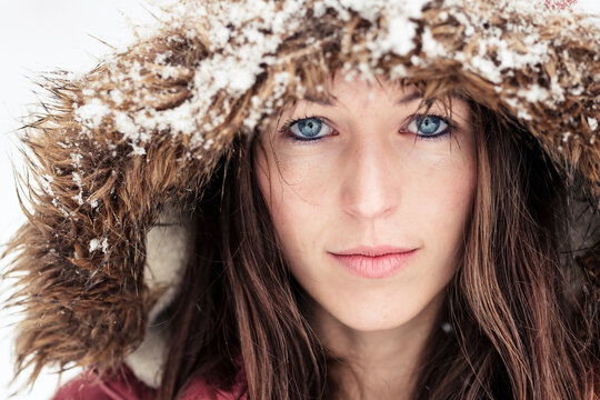 Portrait of young woman with blue eyes in winter