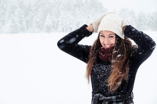 Portrait of happy young woman in winter landscape