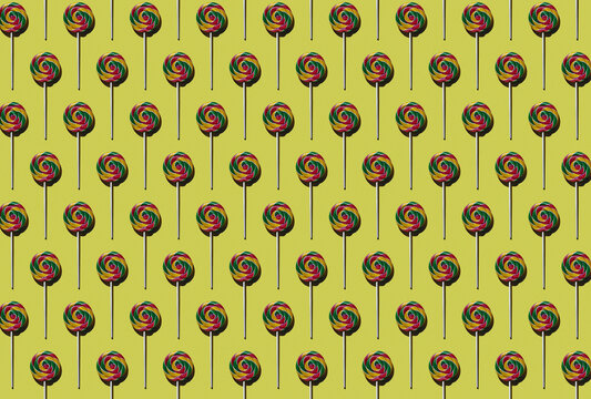 Pattern of multi colored lollipops against yellow background
