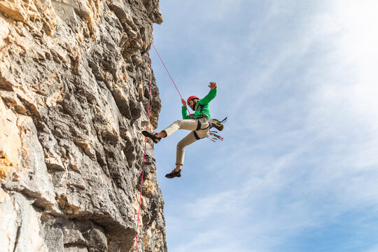 Italy, Cortina d'Ampezzo, man abseiling in the Dolomites mountains