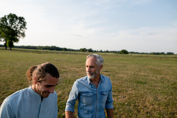 Father with adult son on a meadow in the countryside