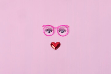 Creative makeup concept with  pink glasses, eyelashes and orchid flowers on the pink background. Makeup concept.