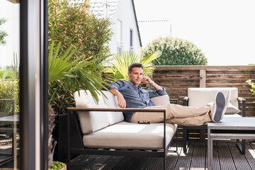 Confident man relaxing on the terrace