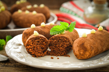 Potato cake on a white plate decorated with a sprig of mint. Russian dessert.
