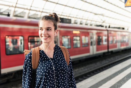 Portrait of smiling young woman at the train station
