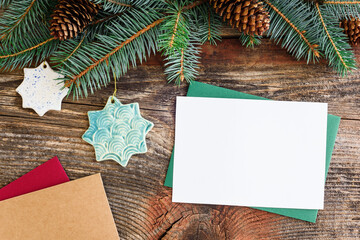 Christmas background concept. Multicolored cards. Christmas tree branches with cones.