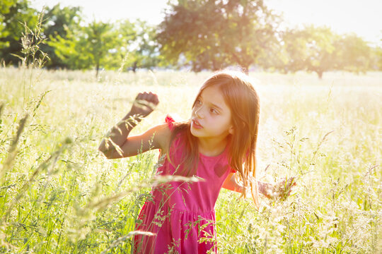 Portrait of little girl standing in summer meadow