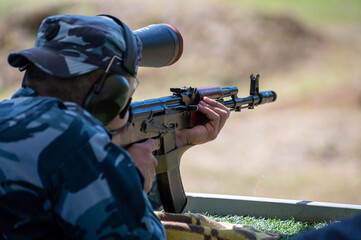 Shooting on target in shooting range. Back close-up detail view