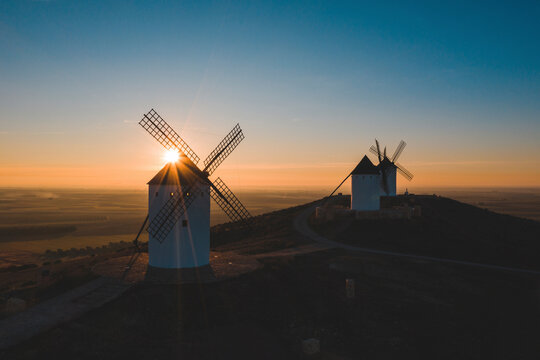 Spain, Province of Ciudad Real, Alcazar de San Juan, Old windmills standing on top of hill at sunset
