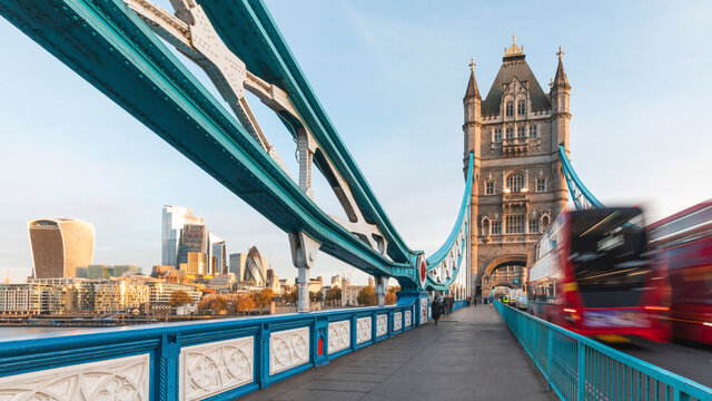 UK, England, London, Blurred motion of&Ocirc;&oslash;&Omega;double-decker&Ocirc;&oslash;&Omega;bus driving across Tower bridge at dawn